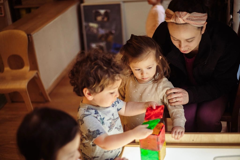 Roots students playing with magnatiles